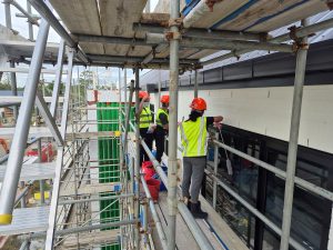 Post construction cleaning showing our team on scaffolding cleaning a building from the outside