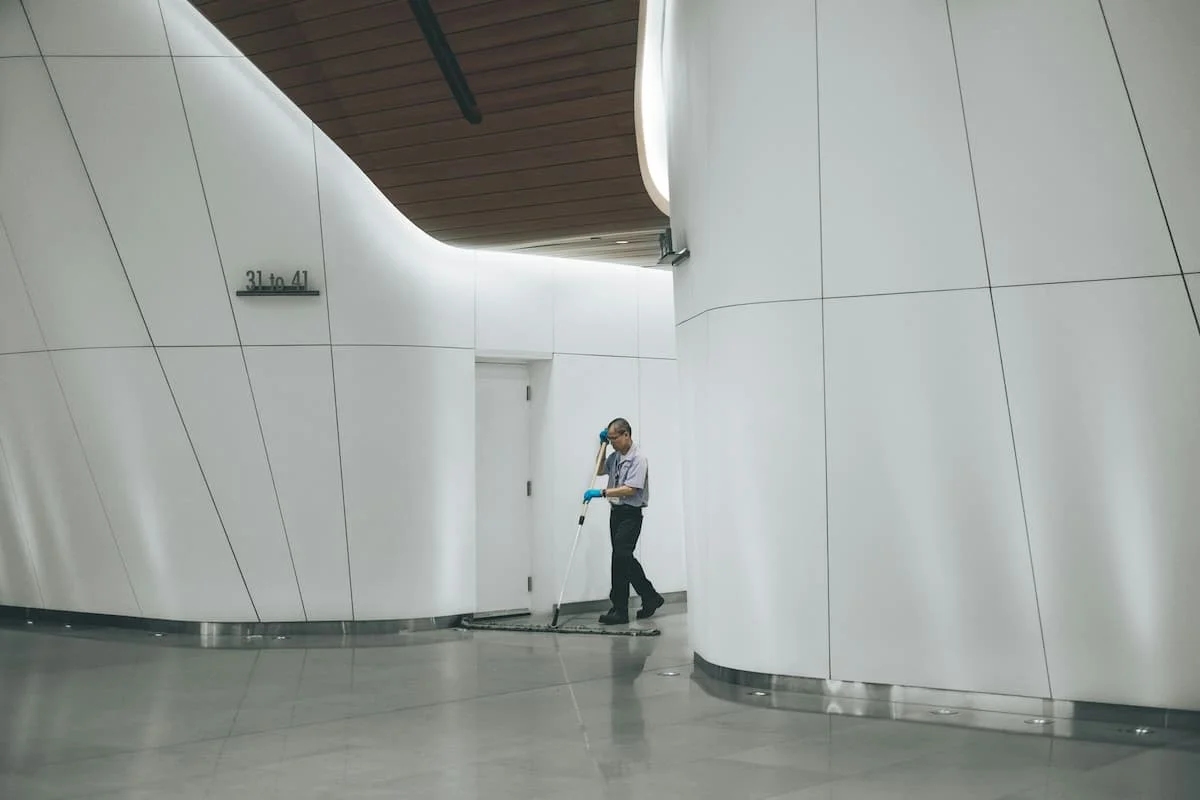 Cleaner sweeping an office